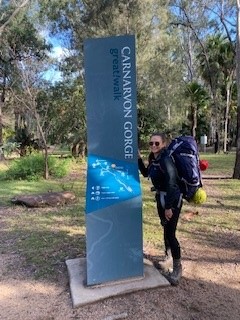 A photo of Hannah in front of the Carnarvon Gorge great walk sign.